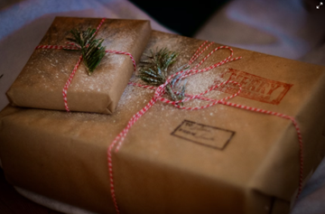 Two packages wrapped in brown paper and red string.