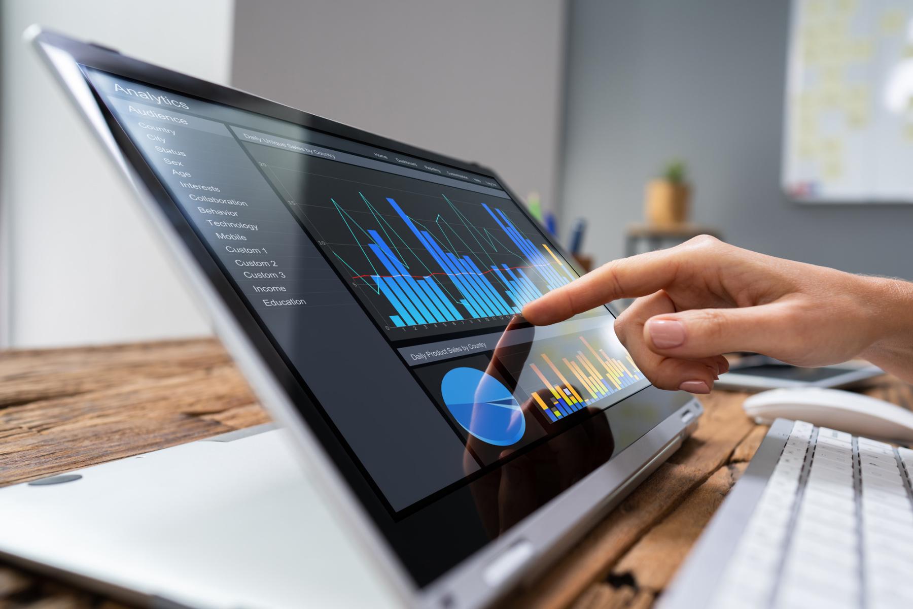 A computer on a table showing programmatic advertising data